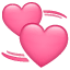 To hjerter som sirkler rundt en emoji U+1F49E